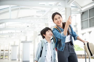 Couple of tourists ready for travel with paper map and brights mile at airport. Ready for vacation trip, Introduce with happy on sky walk. Family and finding location for education concept.