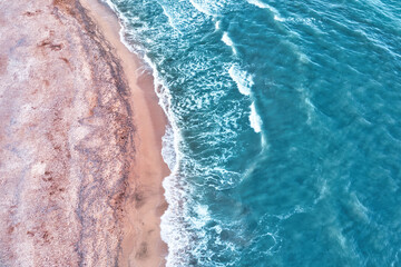Beach view from a drone. A wonderful summer landscape, clean sand and blue water.