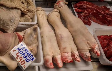 Raw pig trotters and veal snout at a butcher shop in Pamplona, Spain
