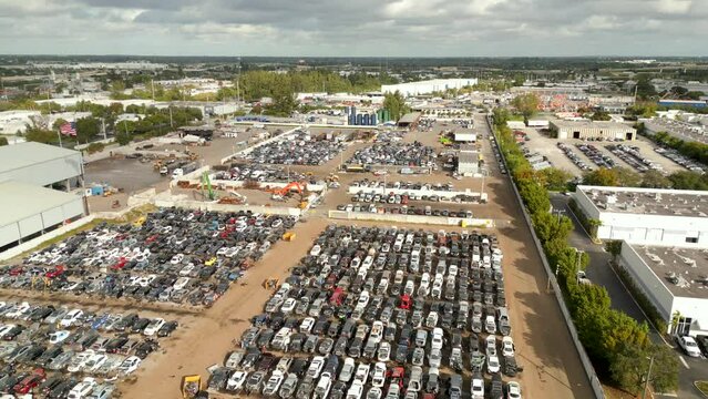 Aerial pull out shot of a automotive junk yard for car parts