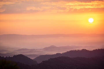 An image landscape forest layer mountain and fog or mist with sun in the travel day vacation in the tourist in start the day winter atmosphere background.