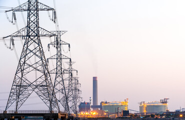 Fototapeta premium High-voltage poles supply power to the petrochemical industry.