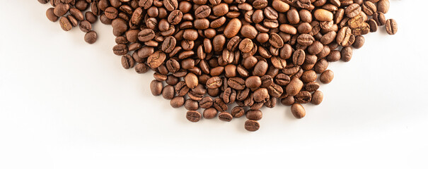 Coffee beans initially cover the white background. View from above. High quality product.