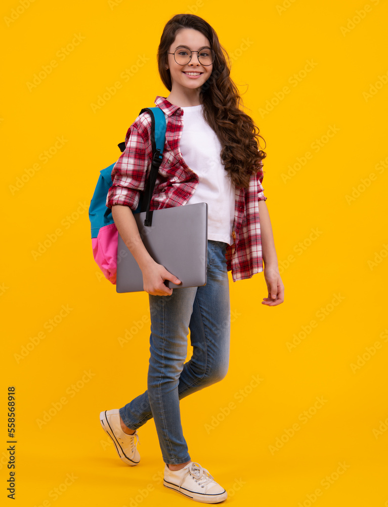 Poster schoolchild, teenage student girl with laptop on yellow isolated studio background. children school 