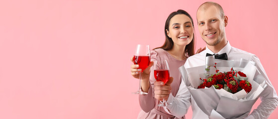Happy young couple with flowers and glasses of wine on pink background with space for text....