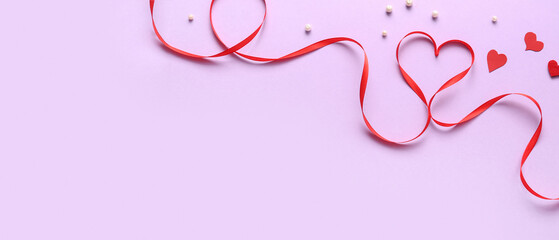 Heart made of red ribbon on lilac background with space for text. Valentine's Day celebration