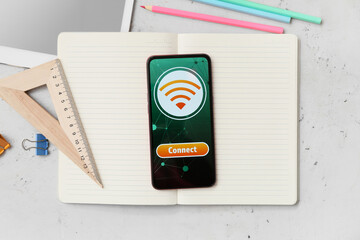 Different stationery supplies and mobile phone with WiFi symbol on light background