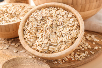 Wooden bowls of raw oatmeal, closeup