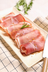 Plate with slices of tasty ham on light table, closeup