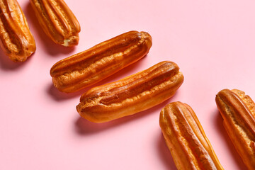 Sweet eclairs on pink background