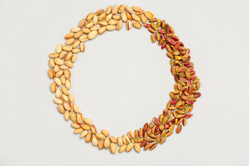 Obraz premium Frame made of tasty pistachio nuts isolated on white background