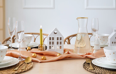 Table setting with candle holders and Christmas balls in dining room