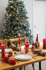 Table setting with candles and Christmas balls in dining room