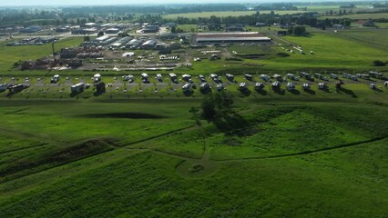 Aerial drone pan across of grassy green Montana Rv park full of mobile homes on summer vacation