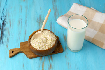 Milk with sesame on wooden background, Healthy drink. Raw food diet. Vegan concept.