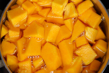 Cooking pumpkin in water, pumpkin soup. Selective focus. Diet soup in a pot.