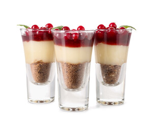 Shots of delicious pudding with cranberry, mint and jam isolated on white background
