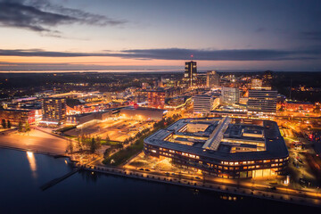 Almere city center illuminated at dusk. Suburban city near Amsterdam, The Netherlands. Aerial view.