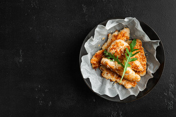 Homemade chicken strips in a ceramic bowl, top view, copy space