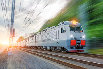 Naklejka premium Passenger electric train traveling speed railway wagons journey light