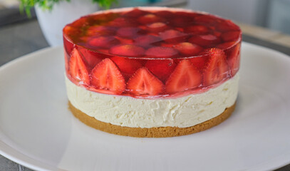 Homemade Cold Strawberry cheesecake jelly tart on white plate