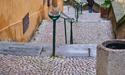 down stone pavement stairs separated by balustrade in old city