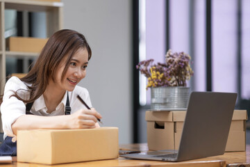 Successful entrepreneur business woman with online sales and Parcel shipping in her home office, prepare parcel box of product for deliver to customer.