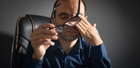 Caucasian man with eye fatigue. Stress. Eyesight problem