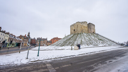 Clifford's Tower , the largest remaining building of York Castle and Fortress during winter snow at...