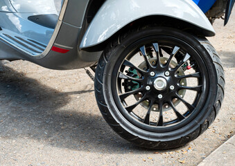 Obraz premium Black color front wheel motorcycle scooter