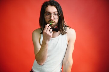 Gay man on a colored background in the studio. The concept of the LGBTQ community. Equality.