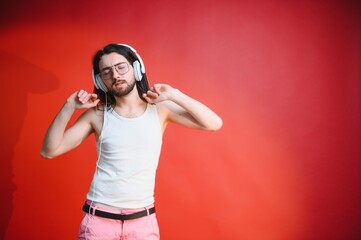 Obraz premium Portrait of a gay man on a colored background. Gender equality. The concept of the LGBT community. Equality.