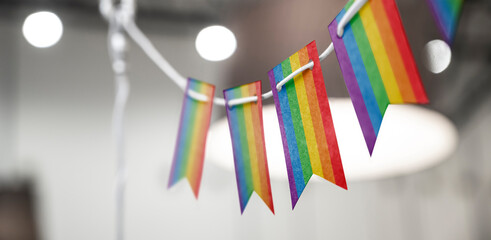 A garland of lgbt national flags on an abstract blurred background