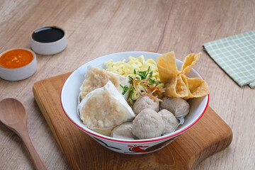 Bakwan Malang or Bakso Malang, traditional food from Malang, East Java, Indonesia. Meatballs soup served with noodles, tofu and fried dumpling (pangsit)
