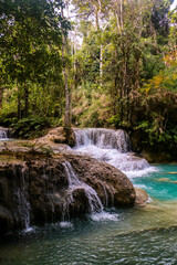 Fototapeta na wymiar Beautiful Kuang Si Waterfall in Laos close to Luang Prabang. Asia travelling to the best nature places (wallpaper)