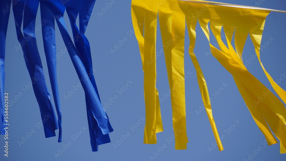 Wall mural blue and yellow stripes hanging on the wind (ukraine flag, the war in ukraine- concept)