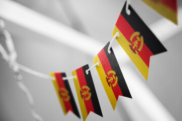 A garland of GDR national flags on an abstract blurred background