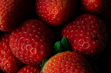 Macro photography of ripe strawberries. Backgrounds and textures. Horizontal photo.
