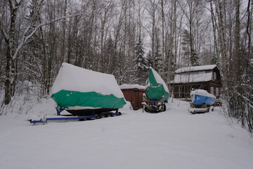 Yacht, boat, ship on the shore under a canopy awning in the snow