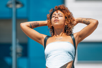 latin african american black girl with tattoos enjoying outdoors on the street