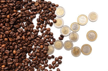 Naklejka premium coffee grains with coins on a white background.