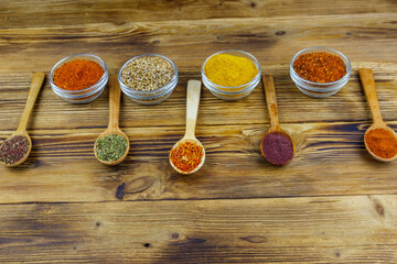 Set of different aromatic spices on wooden table