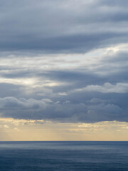 Naklejka na ściany i meble Long aerial view of low storm clouds over Tasman sea coast