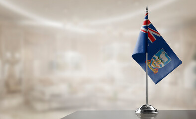 Small flags of the Falkland Islands on an abstract blurry background