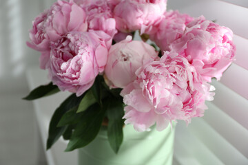 Bouquet of beautiful peonies near window, closeup
