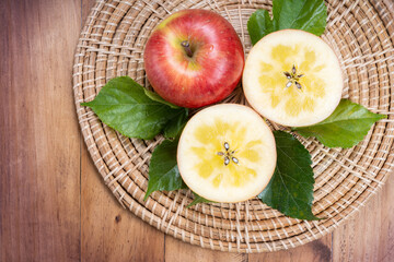 Sweet honey core apple fruit on wooden background, Honey apple on wooden mat over wooden background...