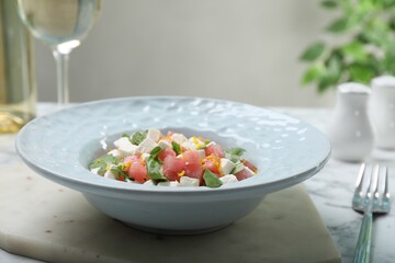 Delicious salad with watermelon, arugula and feta cheese served on white marble table