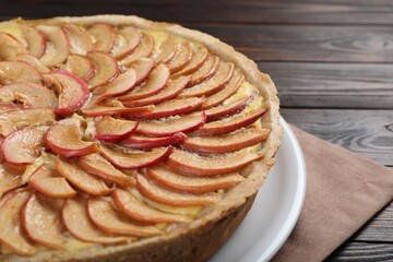 Freshly baked delicious apple pie on wooden table, closeup