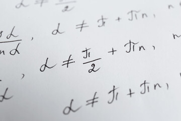 Sheet of paper with different mathematical formulas, closeup