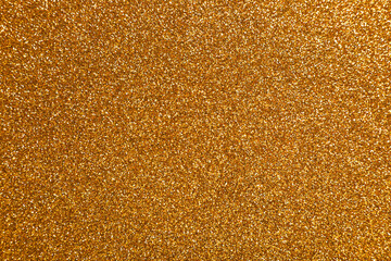 Beautiful shiny golden glitter as background, top view